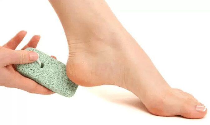 Soak and Scrub Your Feet With A Pumice Stone